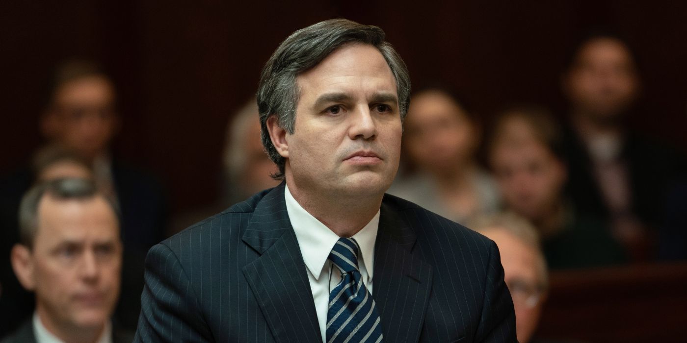 Mark Ruffalo sitting in court with a stern expression on his face in Dark Waters