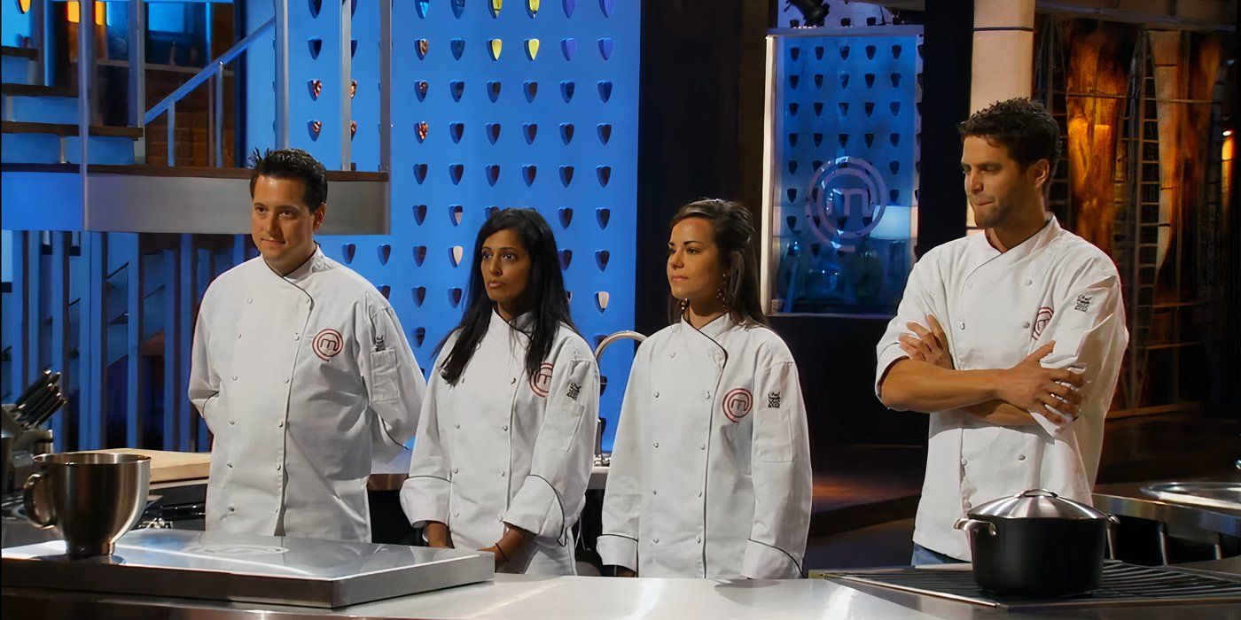 Four chefs standing in a row at a set of tables wearing white jackets in Masterchef.
