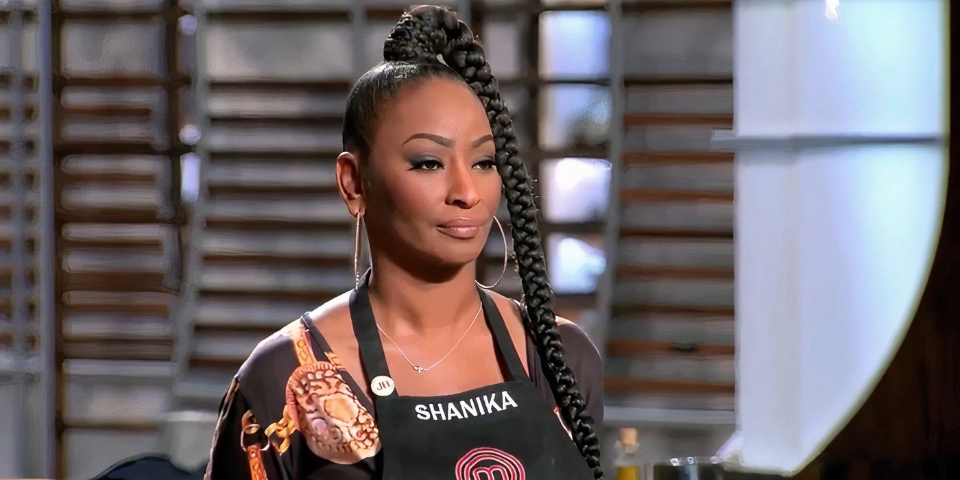 Shanika from Masterchef wearing a black apron and looking serious.
