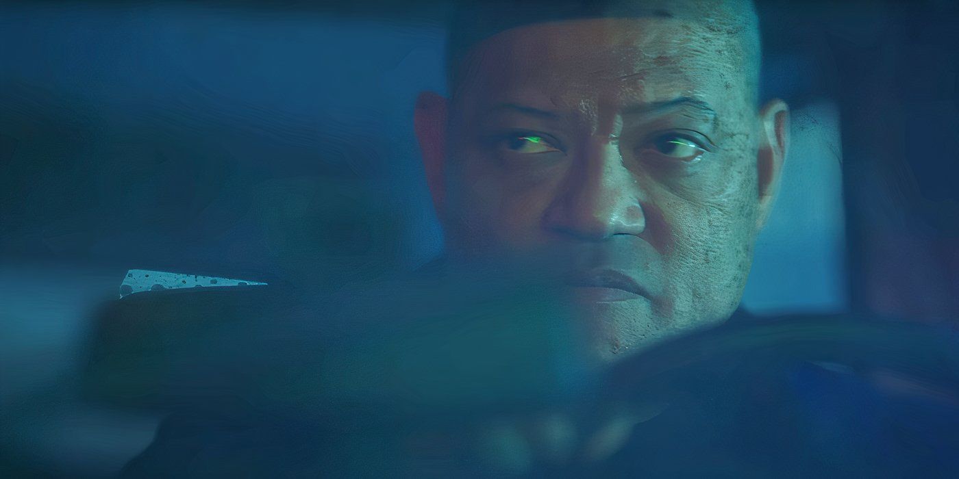 A close-up shot of Laurence Fishburne's face through a car window as he's driving.