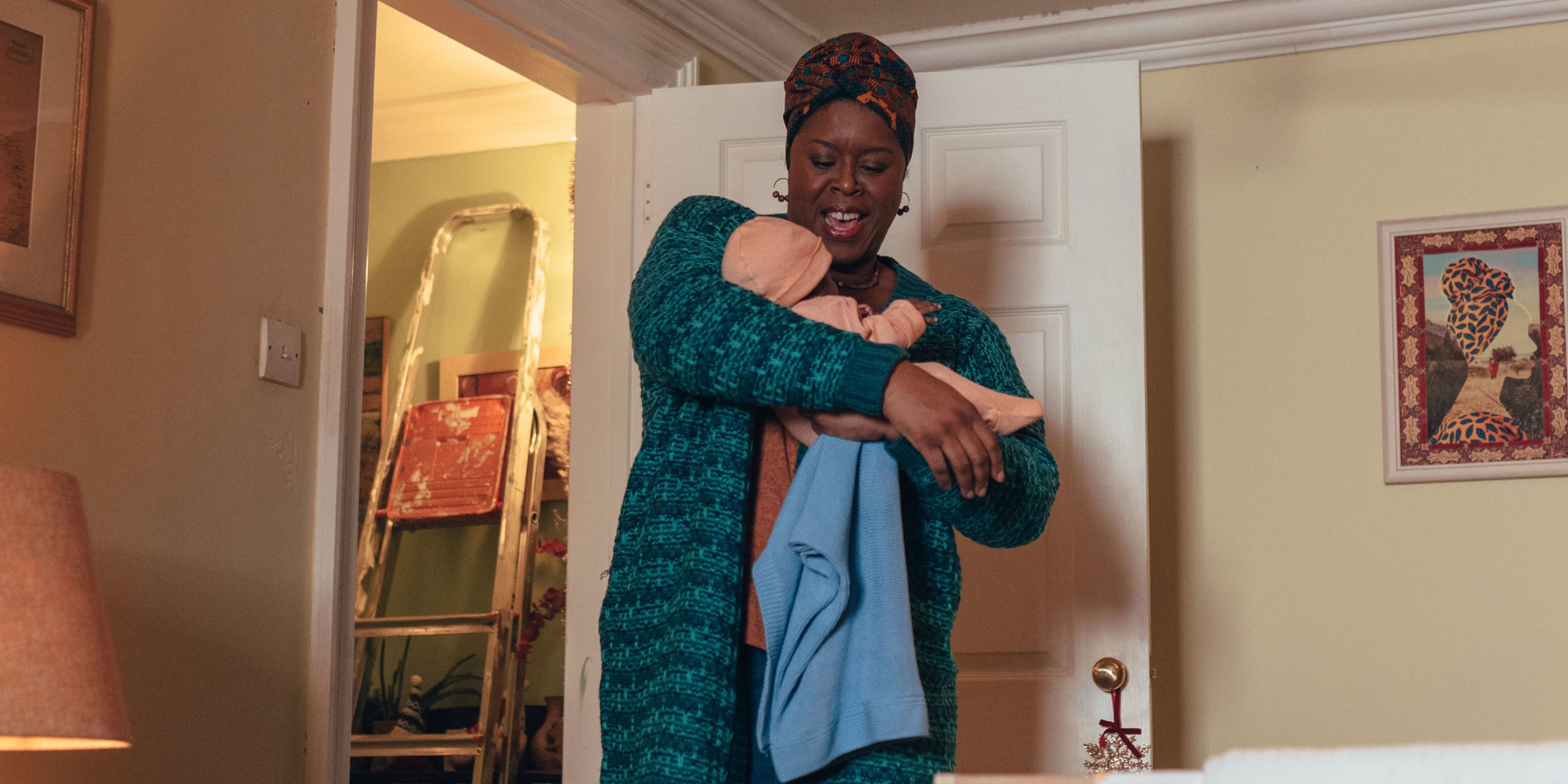 Michelle Greenidge carrying a baby as Carla Sunday in Doctor Who