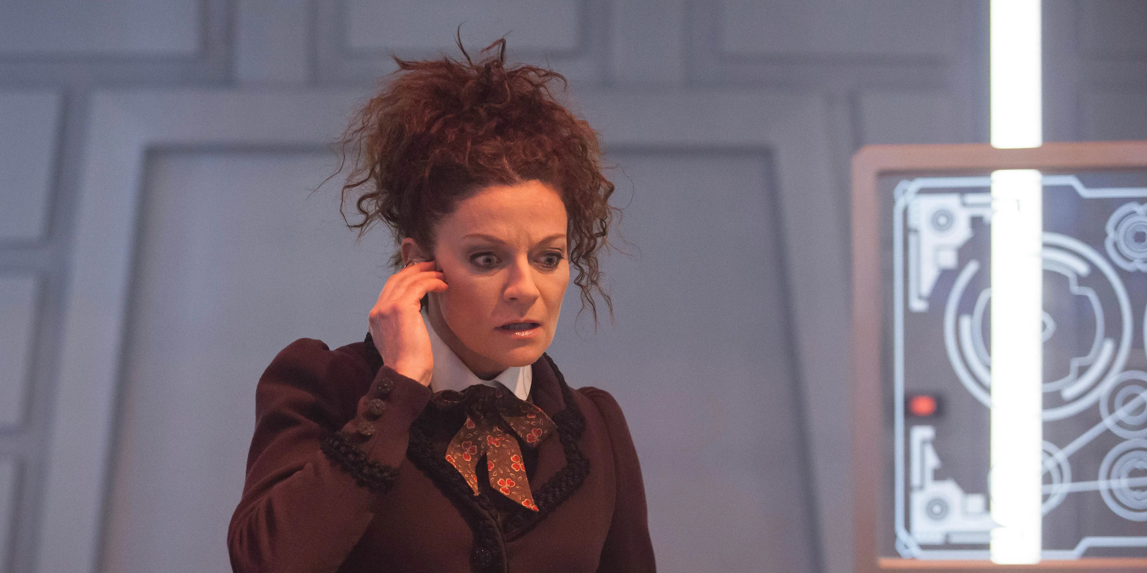 Michelle Gomez as Missy in Doctor Who with her hand to her ear