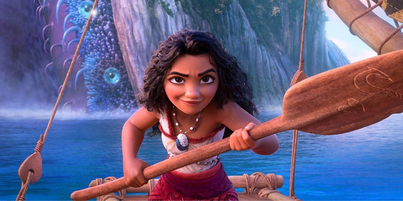 Moana holding a paddle and looking determined while sailing away from a giant tentacle.
