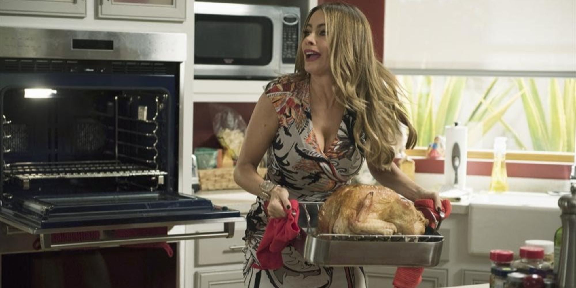 Gloria (Sofia Vergara) holding a turkey in Modern Family