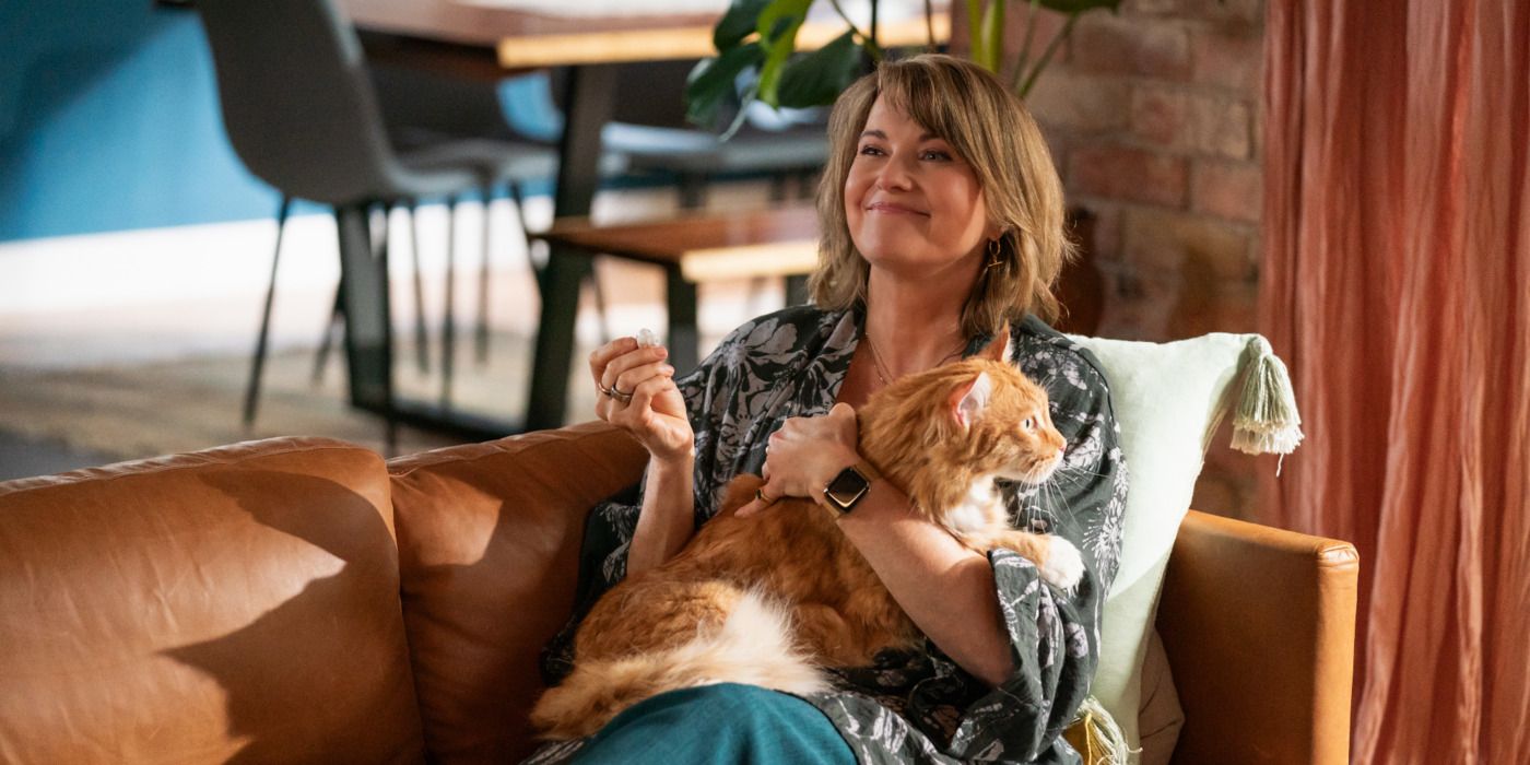 Lucy Lawless as Alexa Crowe lounging with her cat Chowder in My Life Is Murder