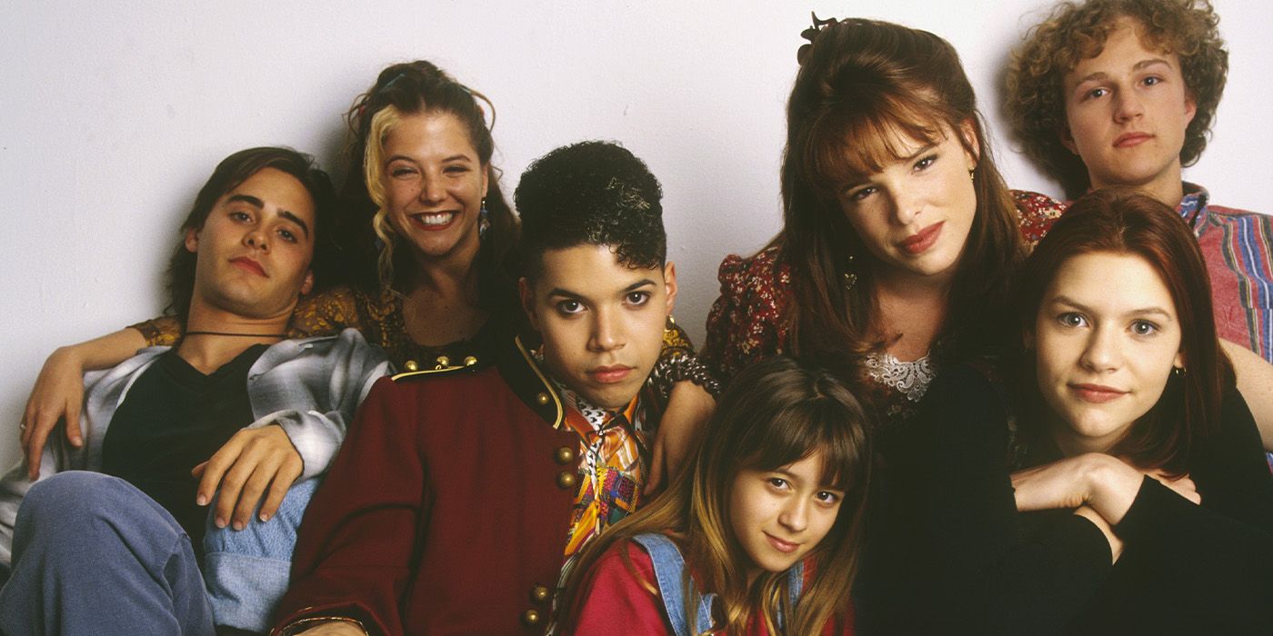 The cast of My So-Called Life sit on the floor together and pose for a photo