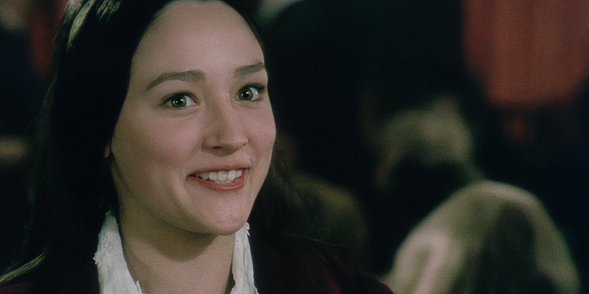 Olivia Hussey smiling as Val in All the Right Noises.