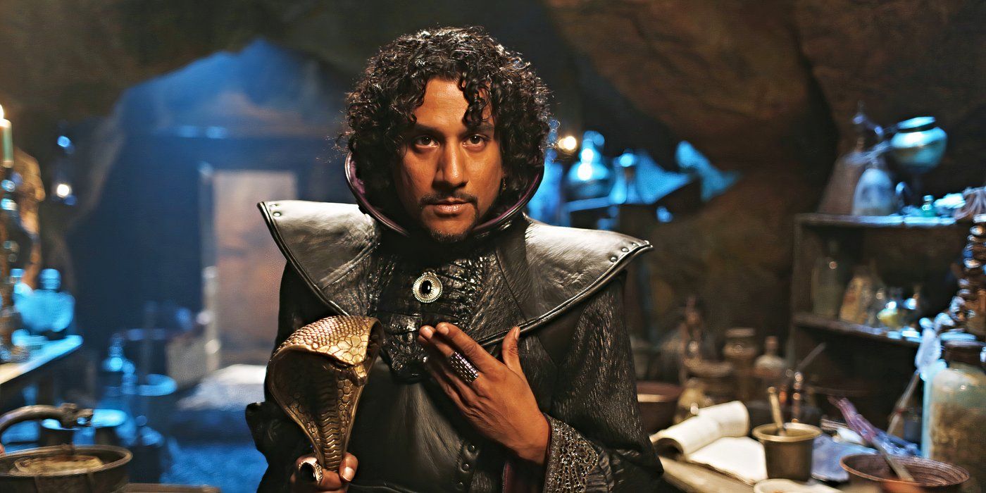 Naveen Andrews as Jafar, holding a snake-shaped staff and wearing a black leather cloak in Once Upon a Time in Wonderland