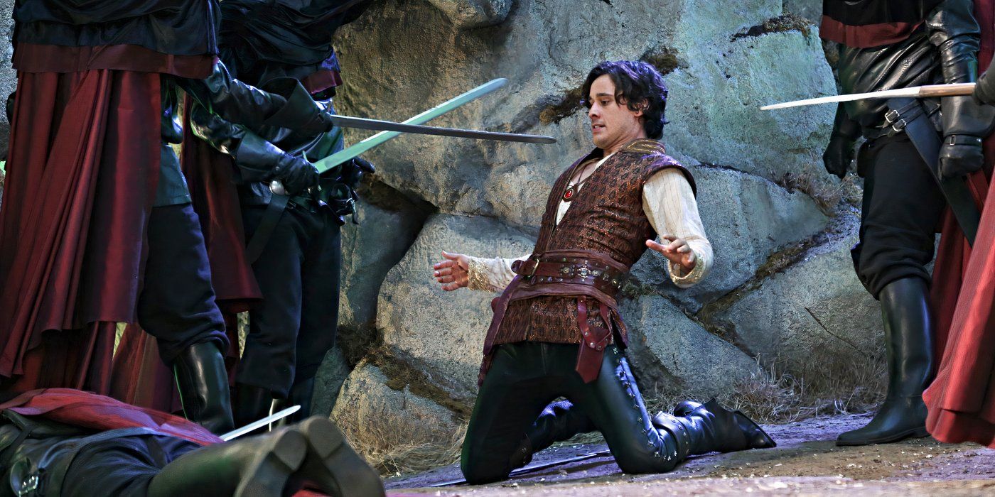 Peter Gadiot com Cyrus, de genolls mentre els cavallers emmascarats li apunten espases a Once Upon a Time in Wonderland