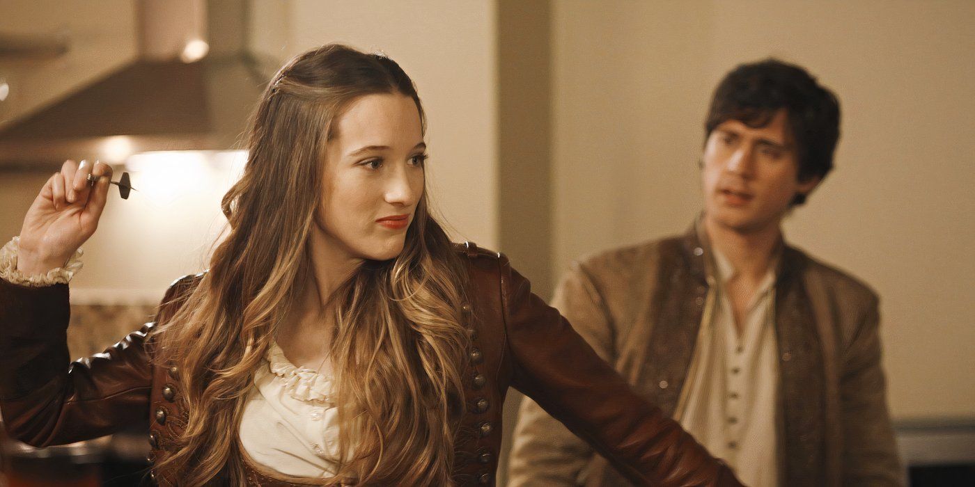 Alice (Sophie Lowe) throws a dart while Cyrus (Peter Gadiot) watches in Once Upon a Time in Wonderland