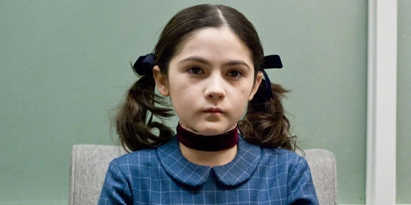 Isabelle Fuhrman as Esther sitting in a chair in Orphan
