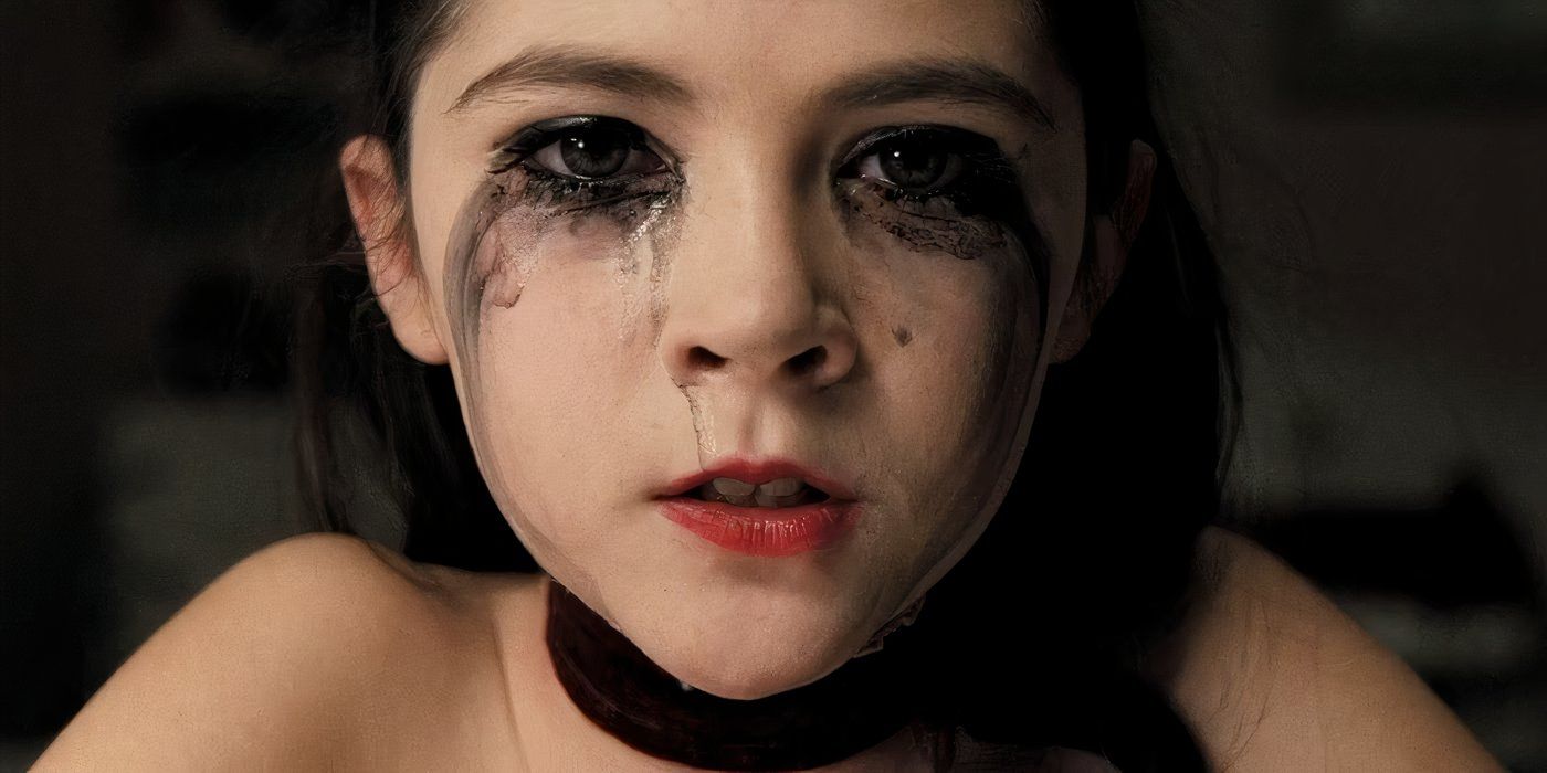 Esther (Isabelle Fuhrman) stares at the camera with black makeup and tears running down her cheeks