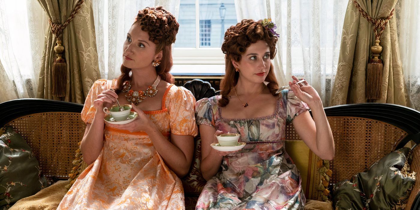 Philippa and Prudence sitting on a sofa holding cups of tea in 'Bridgerton' Season 3