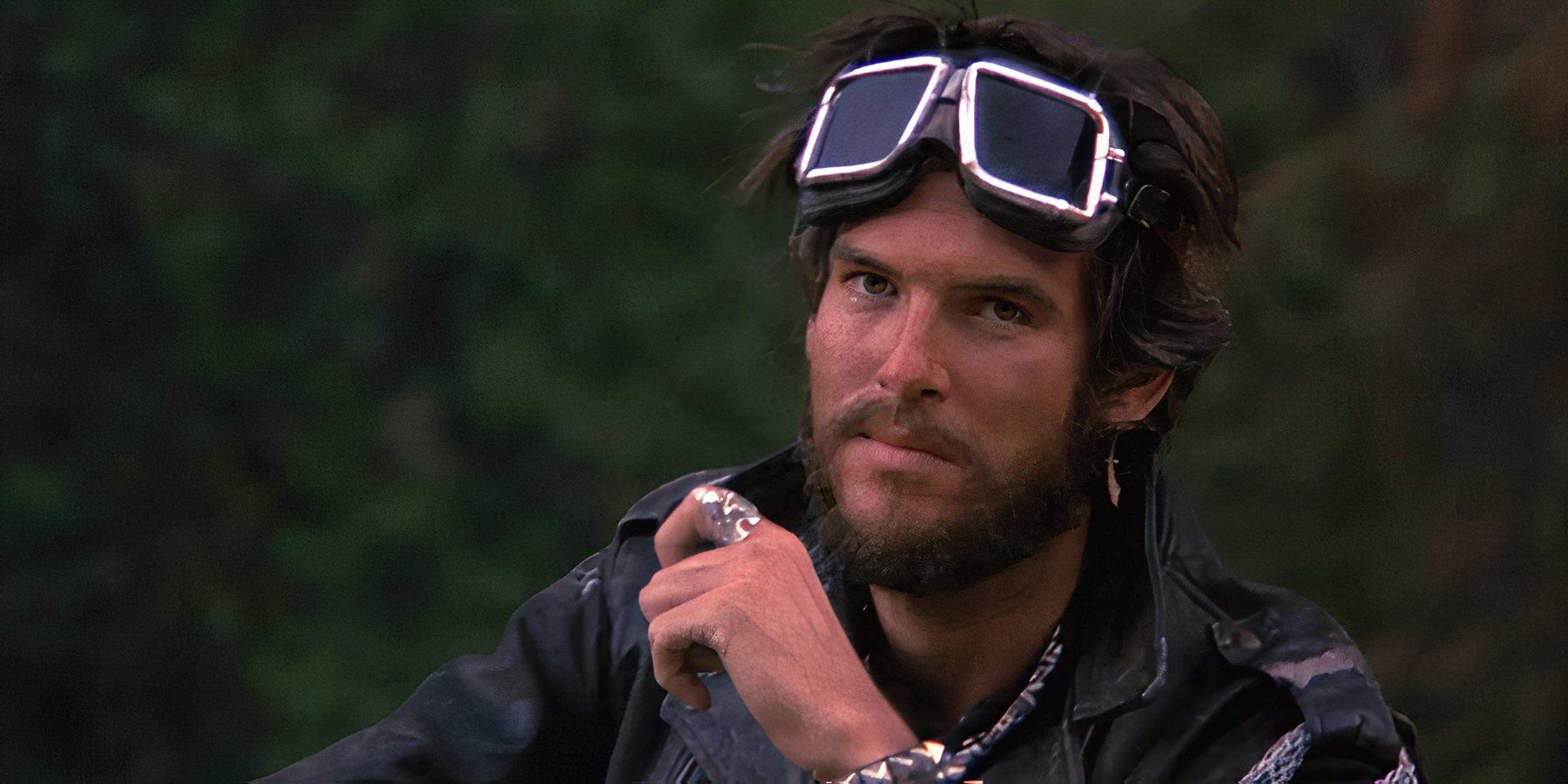 Pierce Brosnan in a motorcyclist outfit looking intently ahead in 'Nomads'