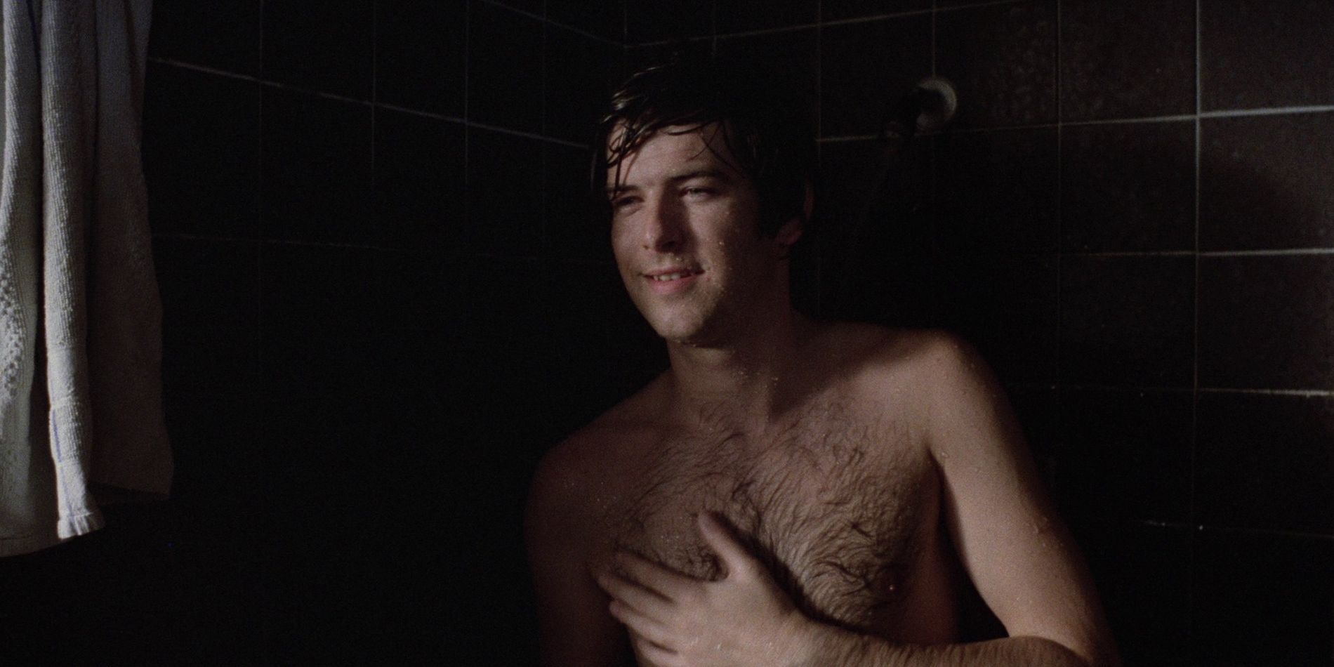 A young man taking a shower in 'The Long Good Friday'