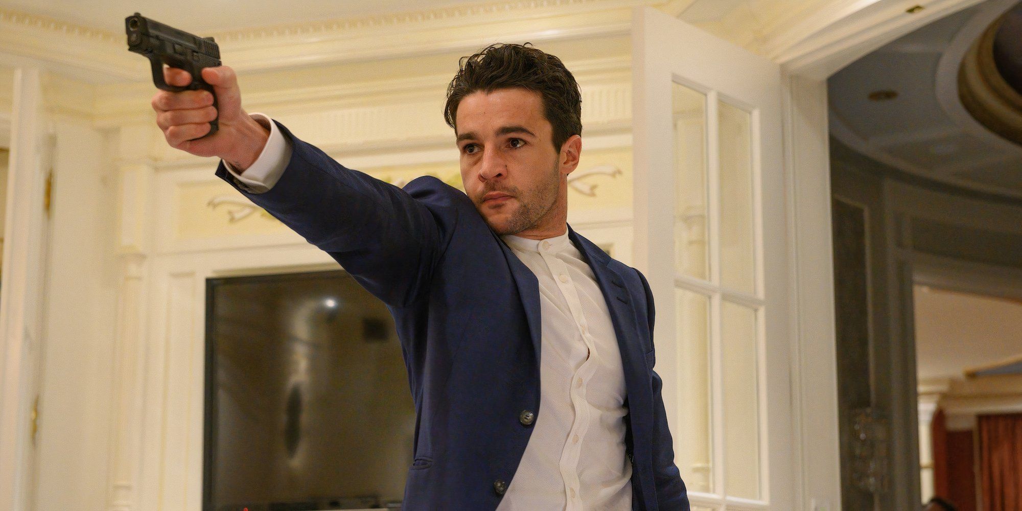 Christopher Abbott as Colin Tate holding a gun in Possessor 