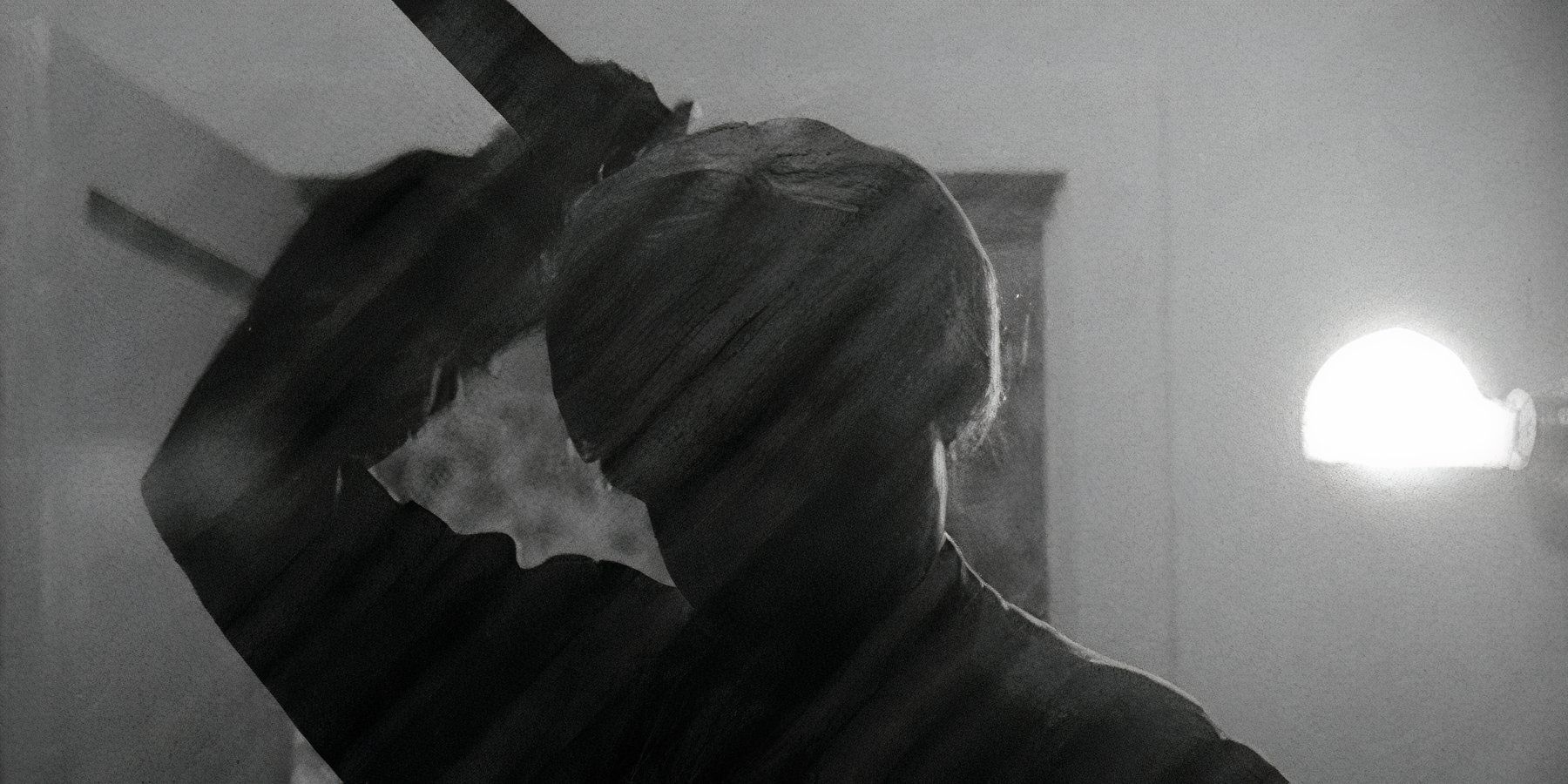 Norman Bates brandishes a large knife in a starkly lit silhouette in Hitchcock’s Psycho.