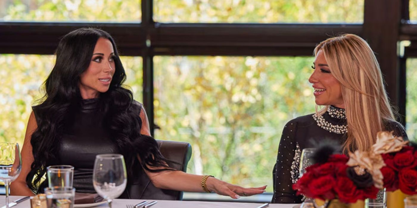 Rachel Fuda and Danielle Cabral, talking to each other over the dinner table, in The Real Housewives of New Jersey Season 14