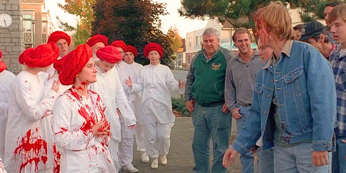 Members of The Church of the Red Museum engage with townspeople who throw blood on their white clothes in The X-Files