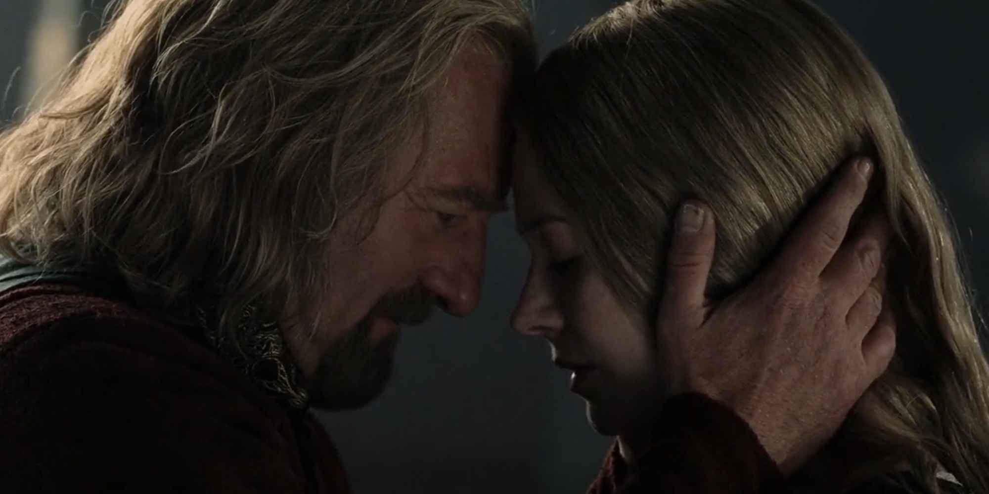 Theoden, played by actor Bernard Hill, holds Eowyn's head, played by actor Miranda Otto, in his hands as they press their forheads together in Lord of the Rings: The Return of the King.