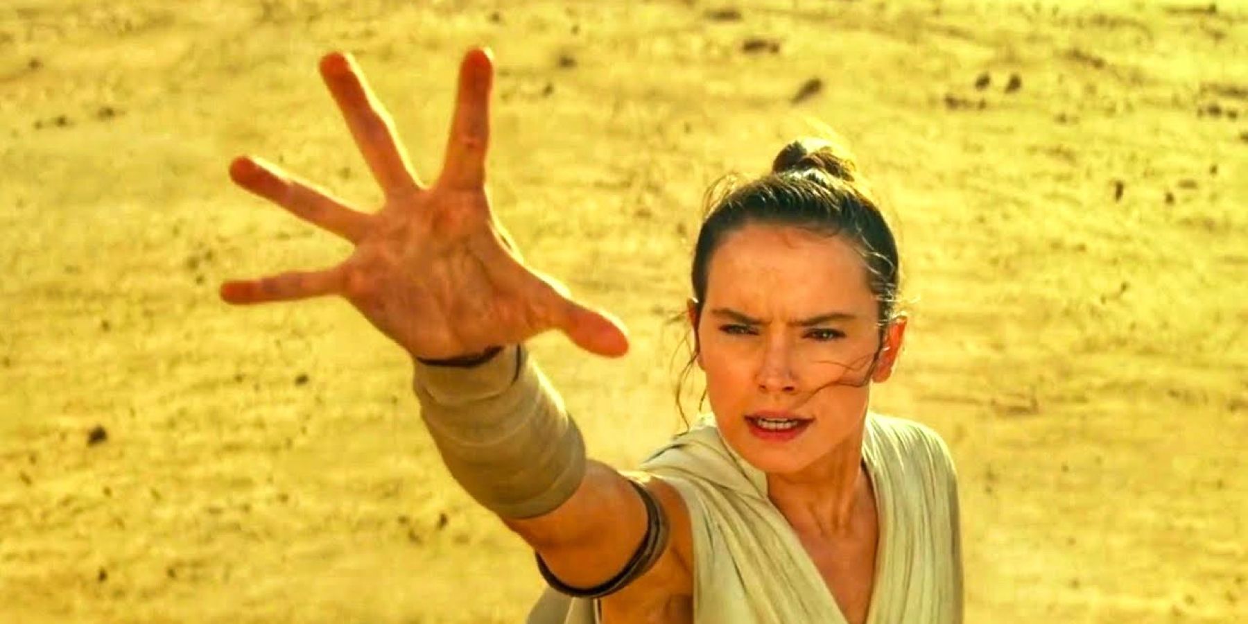 Daisy Ridley as Rey holds up her hand, using the Force in Star Wars: The Rise of Skywalker.