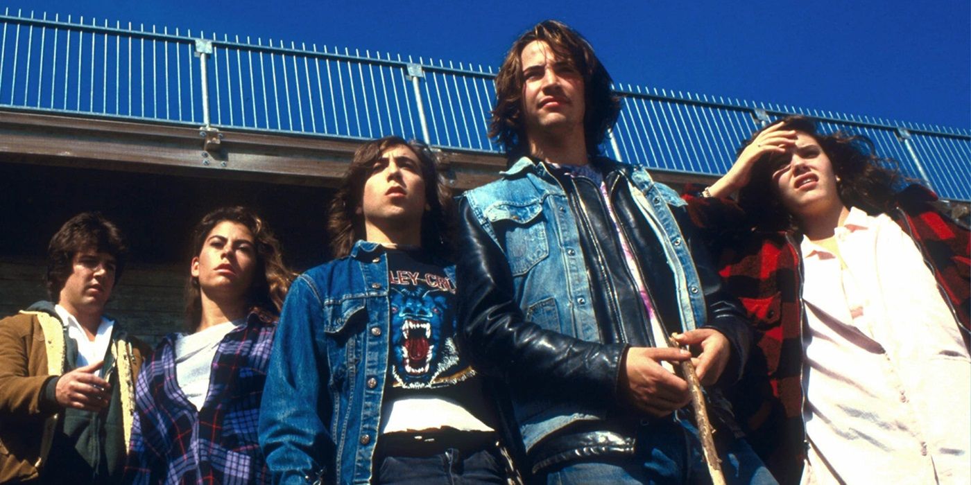 The ensemble cast of River's Edge standing together under a bridge