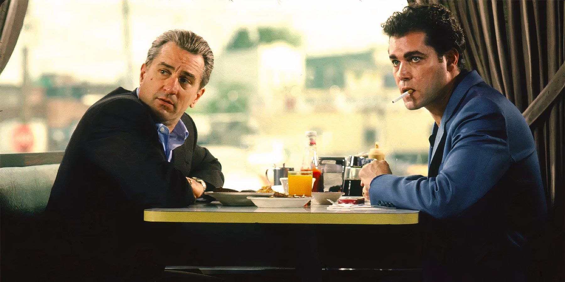 Robert De Niro as James Conway and Ray Liotta as Henry Hill share a meal at a diner in Goodfellas