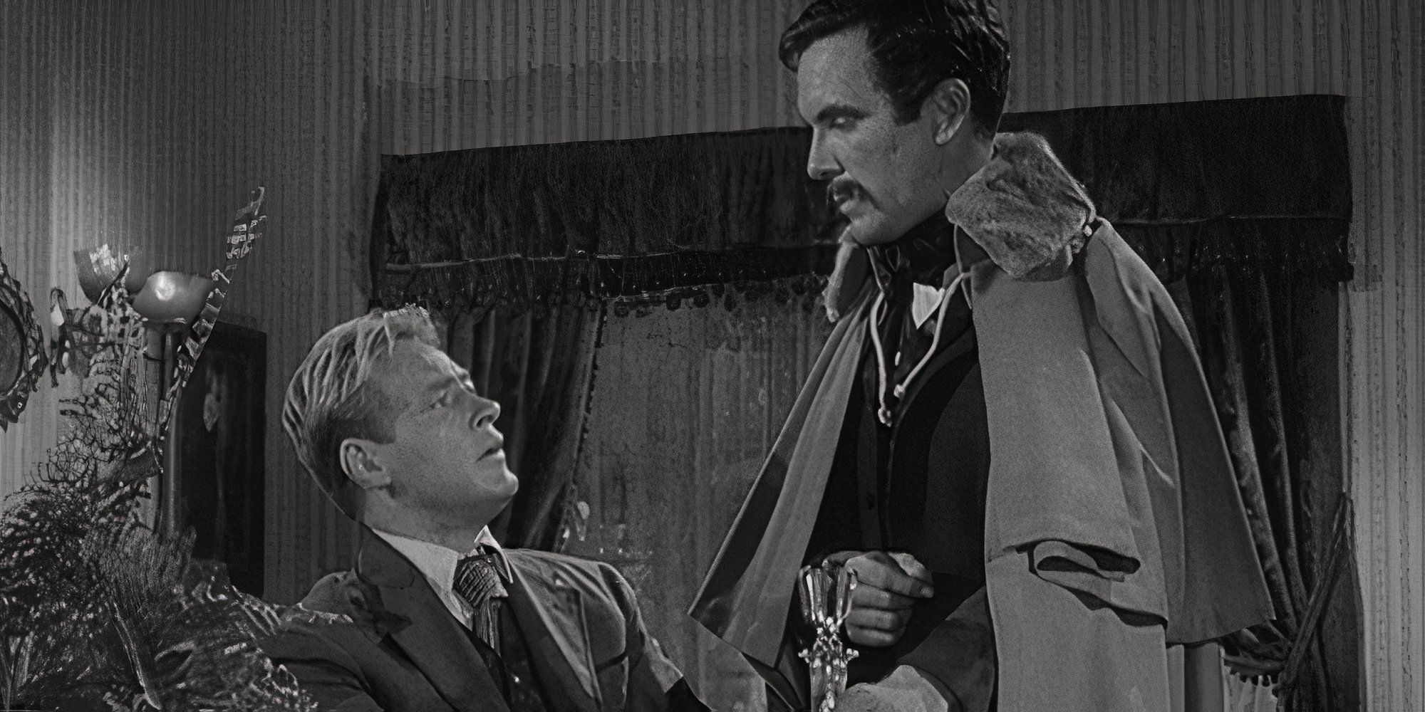 Russell Johnson sitting looking up at John Lasell who is standing in front of him in The Twilight Zone