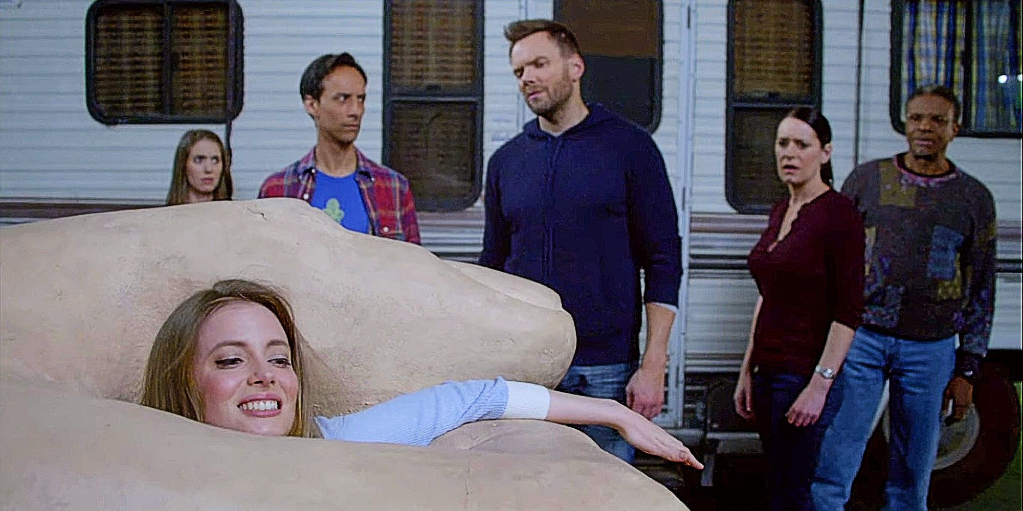 Britta Perry stuck in a giant hand in Community, with Annie, Abed, Jeff, Frankie, and Elroy in the background