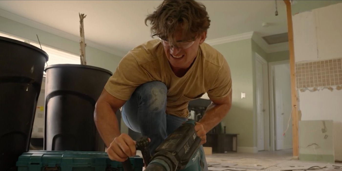 Tyler Cameron uses a tool to chip tile on &lsquo;Going Home With Tyler Cameron&rsquo;