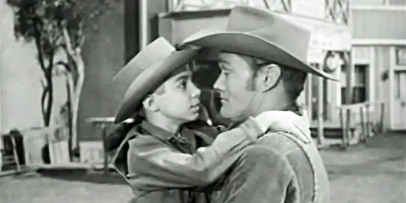 Luke McCain (Chuck Connors) holding Mark McCain (Johnny Crawford) in his arms in The Rifleman