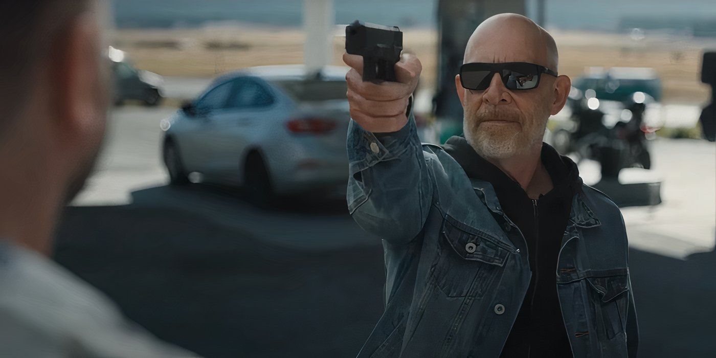 J.K. Simmons pointing a gun in 'You can't Run Forever'