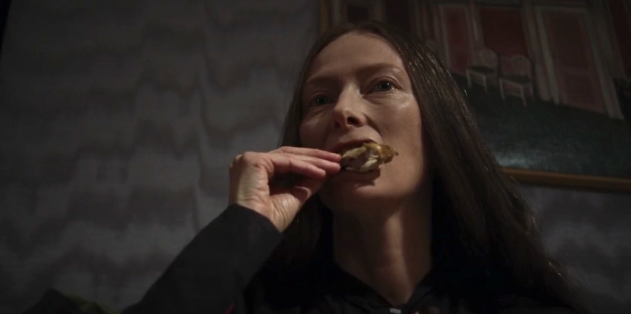 Tilda Swinton is a chicken wing-loving witch in Suspiria (2018).