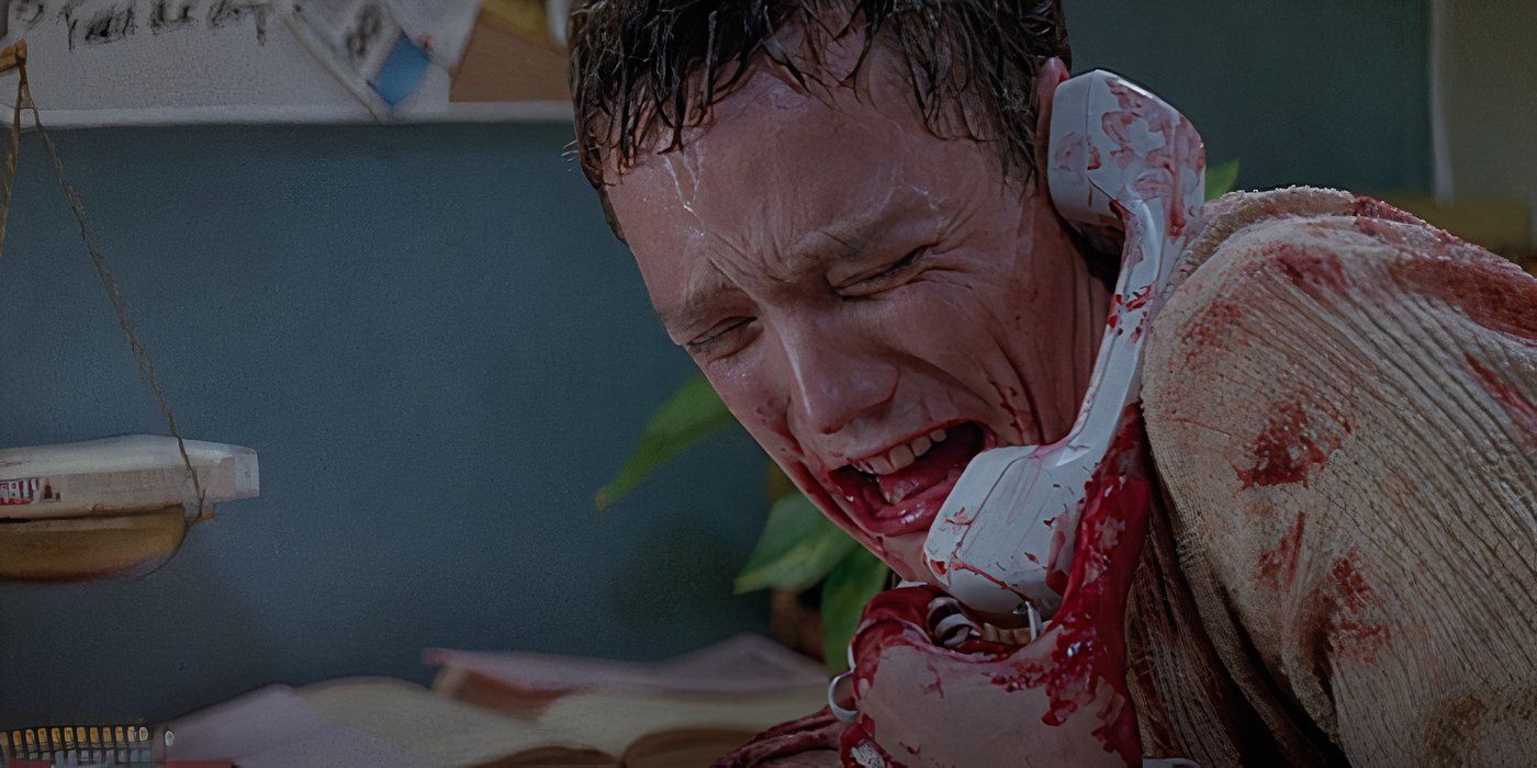 Stu (Matthew Lillard) is bleeding, crying, while talking on the phone in a kitchen in Scream.