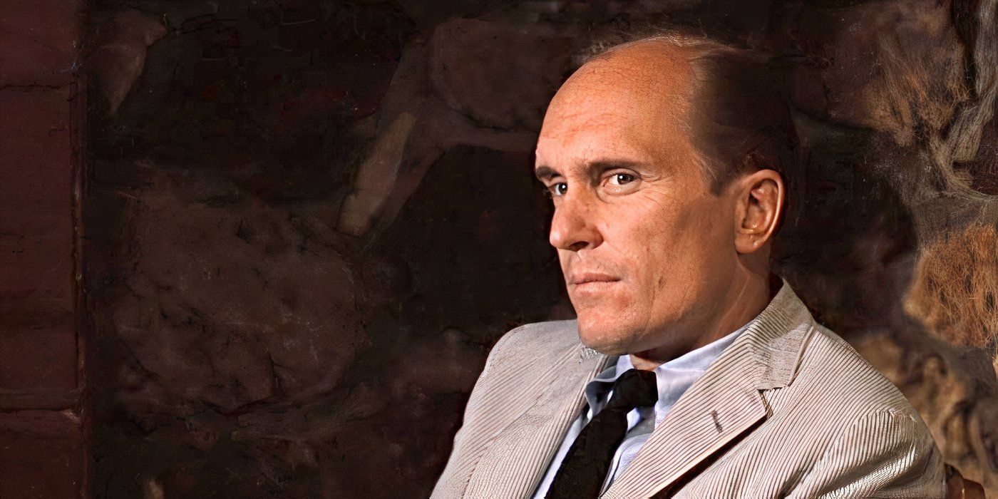 Robert Duvall as Tom Hagen, wearing a suit and looking intensely at something offscreen in The Godfather Part II