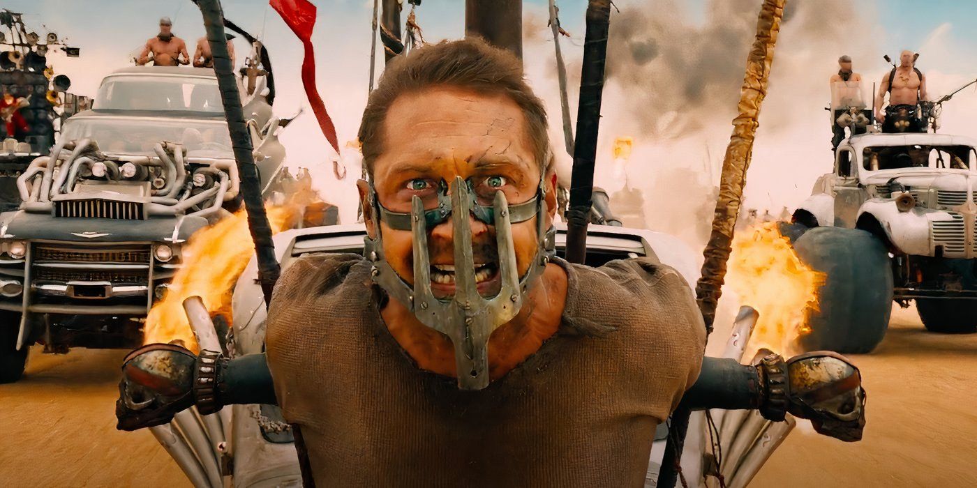 Max (Tom Hardy) is stuck in the front of a vehicle in Mad Max: Fury Road (2015).