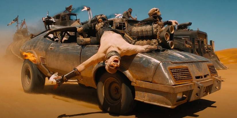 One of the War Boys cheering, hanging off the hood of the "Razor Cola" in Mad Max: Fury Road (2015).