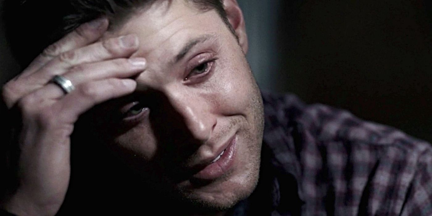 Jensen Ackles as Dean Winchester, crying and holding his head as he talks to a dead Sam in the Season 2 finale of Supernatural