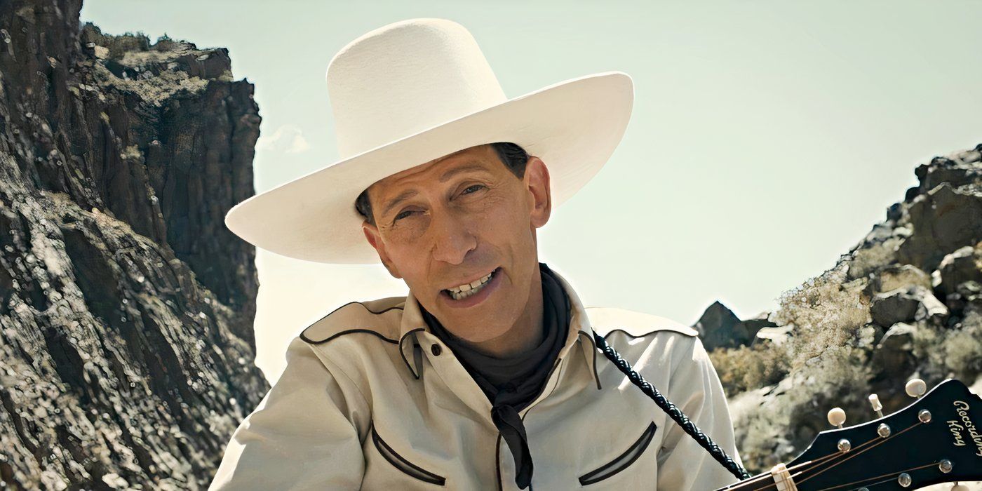 Tim Blake Nelson as Buster Scruggs, leaning toward the camera, wearing a white cowboy hat and holding a guitar in The Ballad of Buster Scruggs