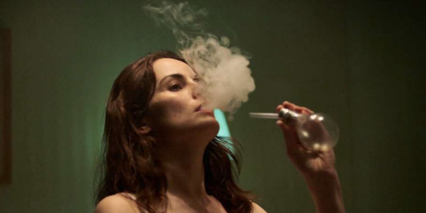 Michelle Dockery as lettie smoking in her hotel room in 'Good Behavior'