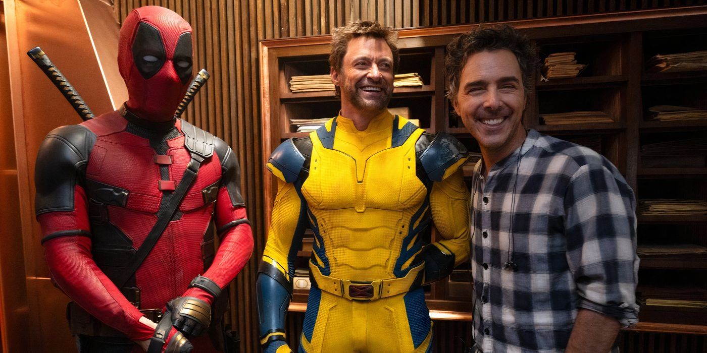 Ryan Reynolds, Hugh Jackman, and Shawn Levy smiling and laughing on set of Deadpool & Wolverine.