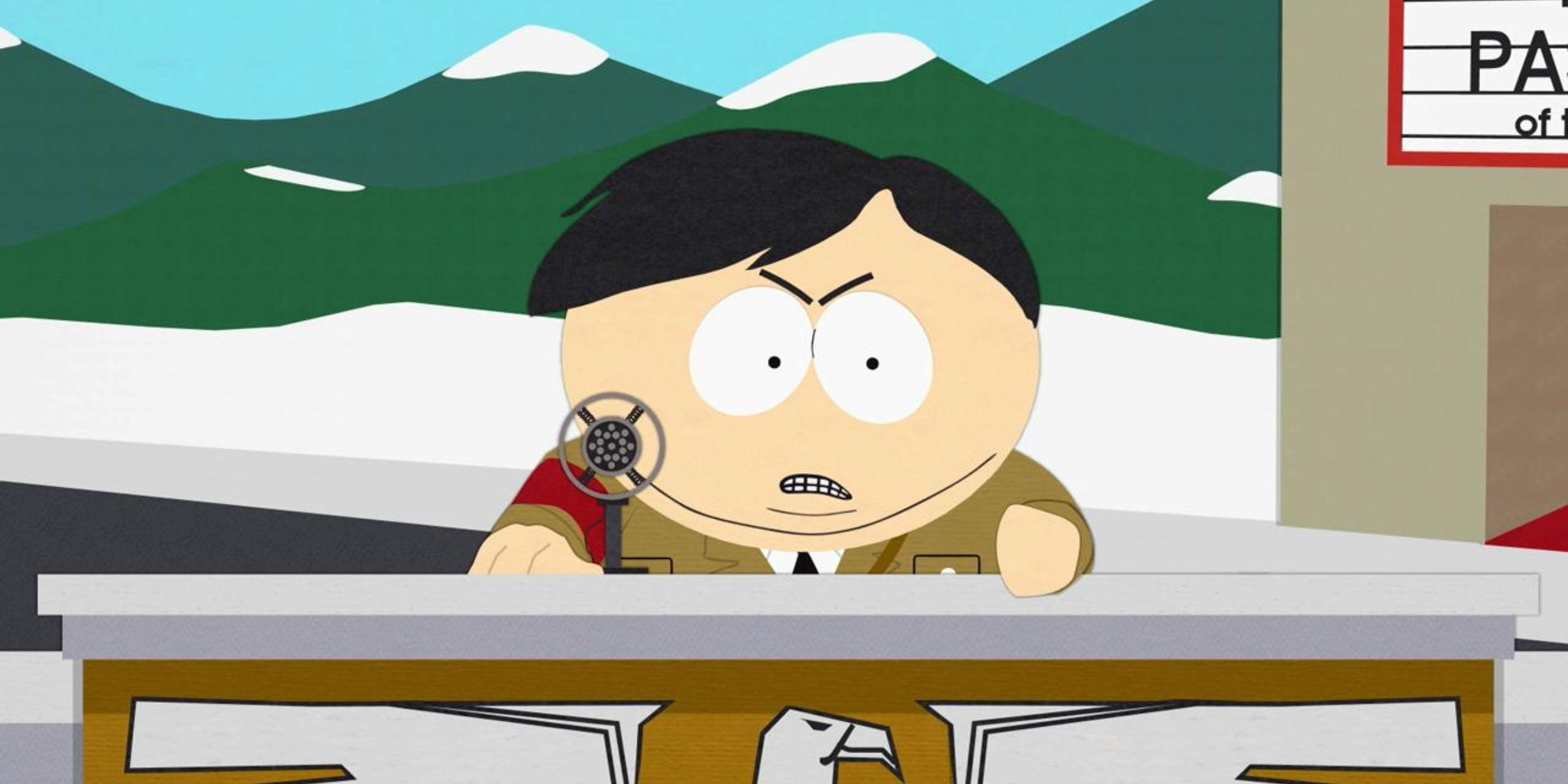 Eric Cartman, dressed as Adolf Hitler, stands at a podium as he gives a speech 