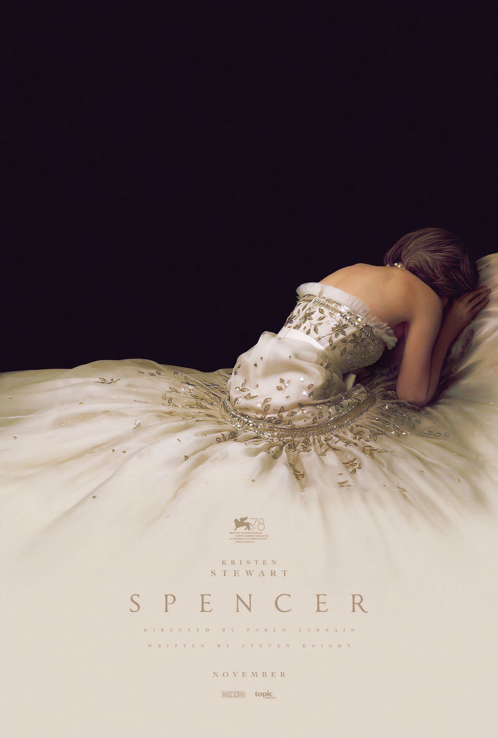 Lady Diana Spencer, played by actor Kristen Stewart, lays despondent in a flowing white gown in the poster for Spencer.