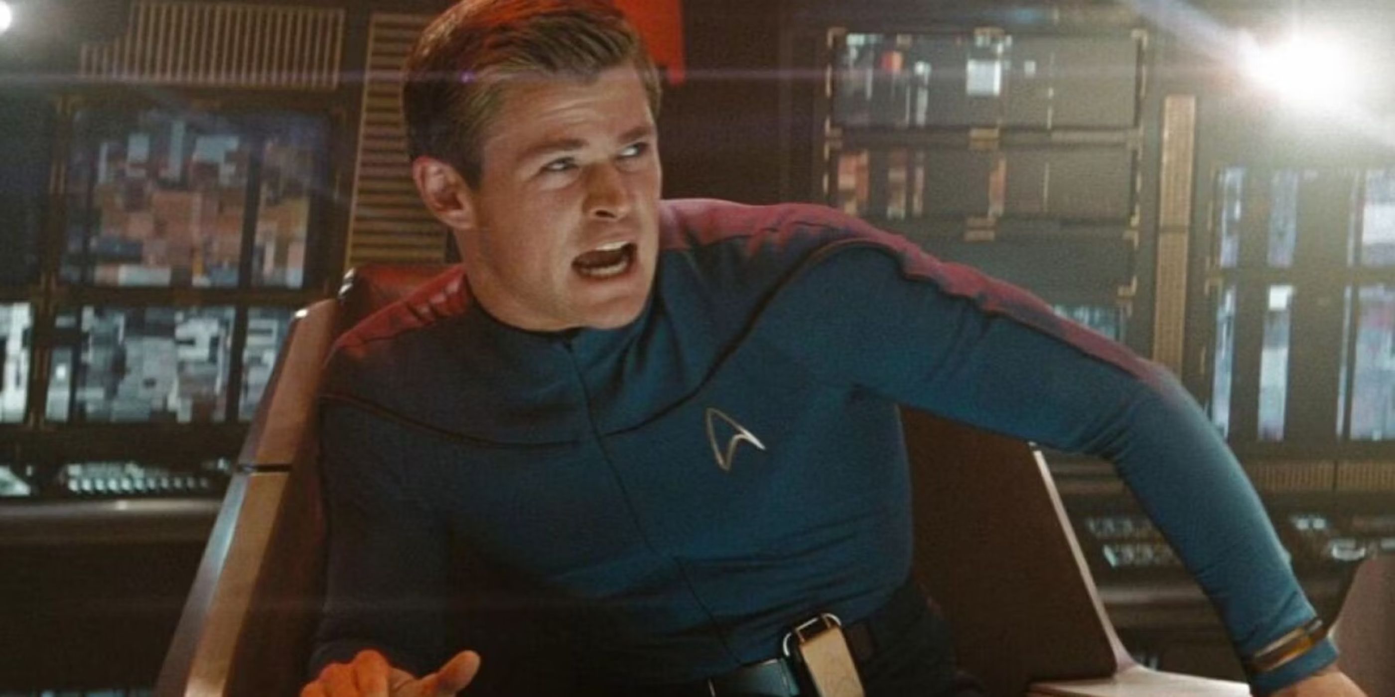 Captain George Kirk (Chris Hemsworth) sits in his chair commanding his ship which is under attack in 'Star Trek' (2009).