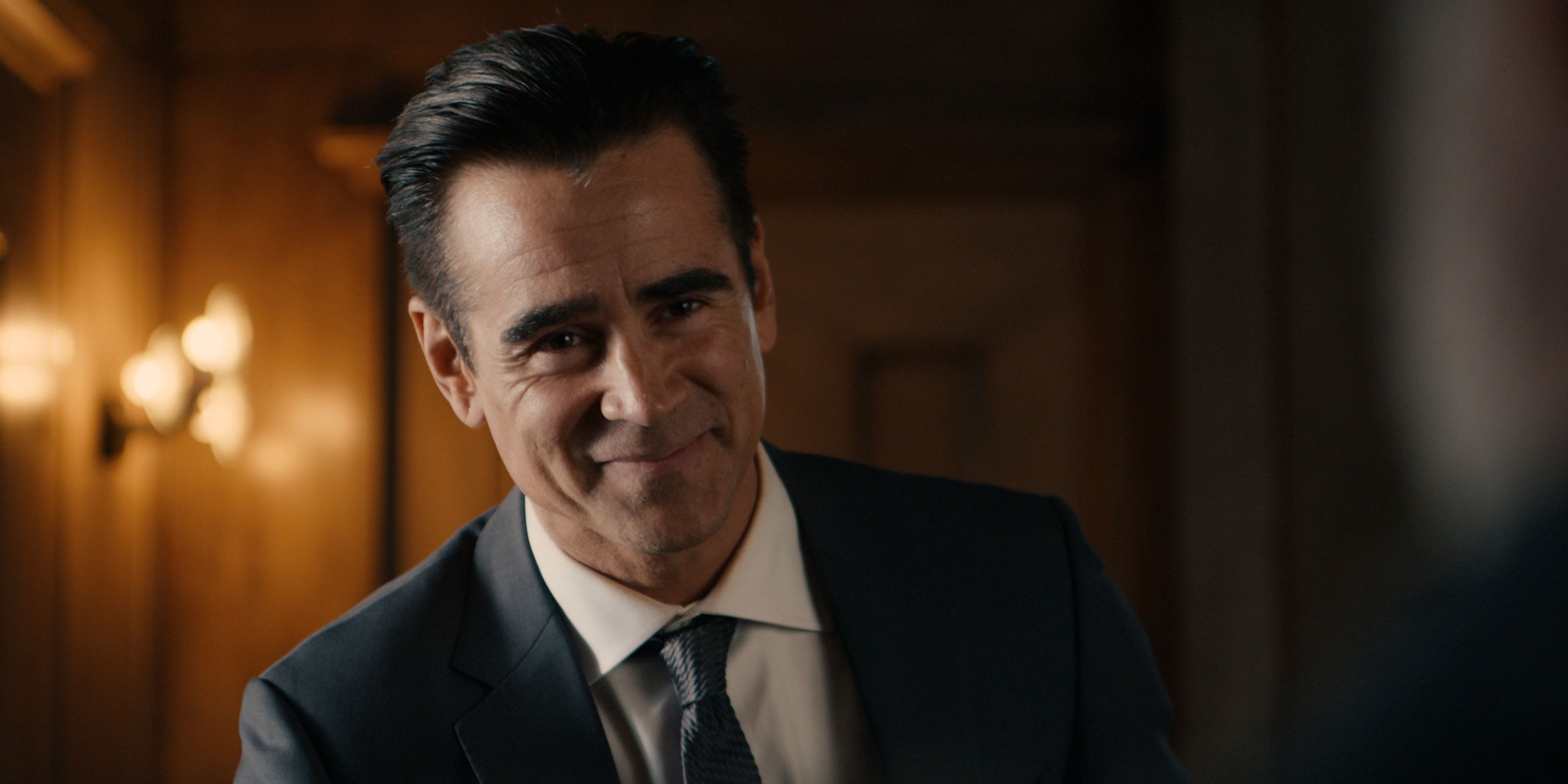 Colin Farrell as private detective John Sugar smiling in a suit and tie in Episode 8 of Apple TV+'s Sugar