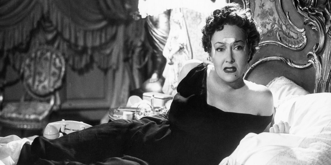 Gloria Swanson as Norma Desmond looking upset on a bed in Sunset Boulevard
