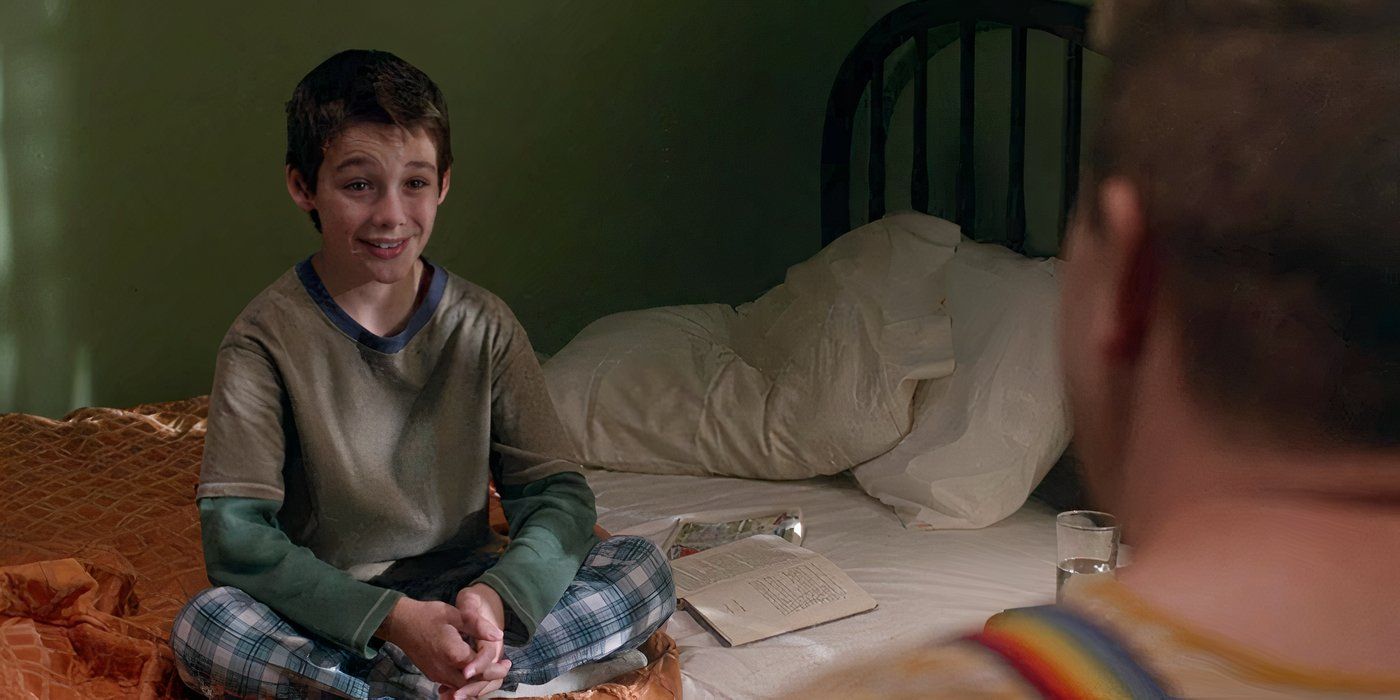 Dylan Kingwell as Young Sam Winchester, sitting on a bed and smiling in the Supernatural episode "Just My Imagination"