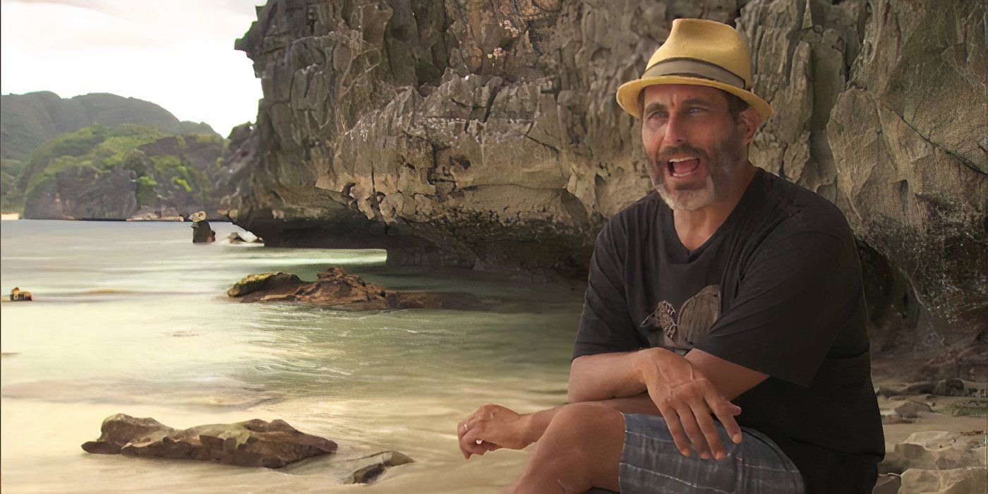 Jonathan Penner de 'Survivor' se sienta en una roca junto al agua, con las piernas cruzadas y los brazos apoyados sobre la roca durante una entrevista.