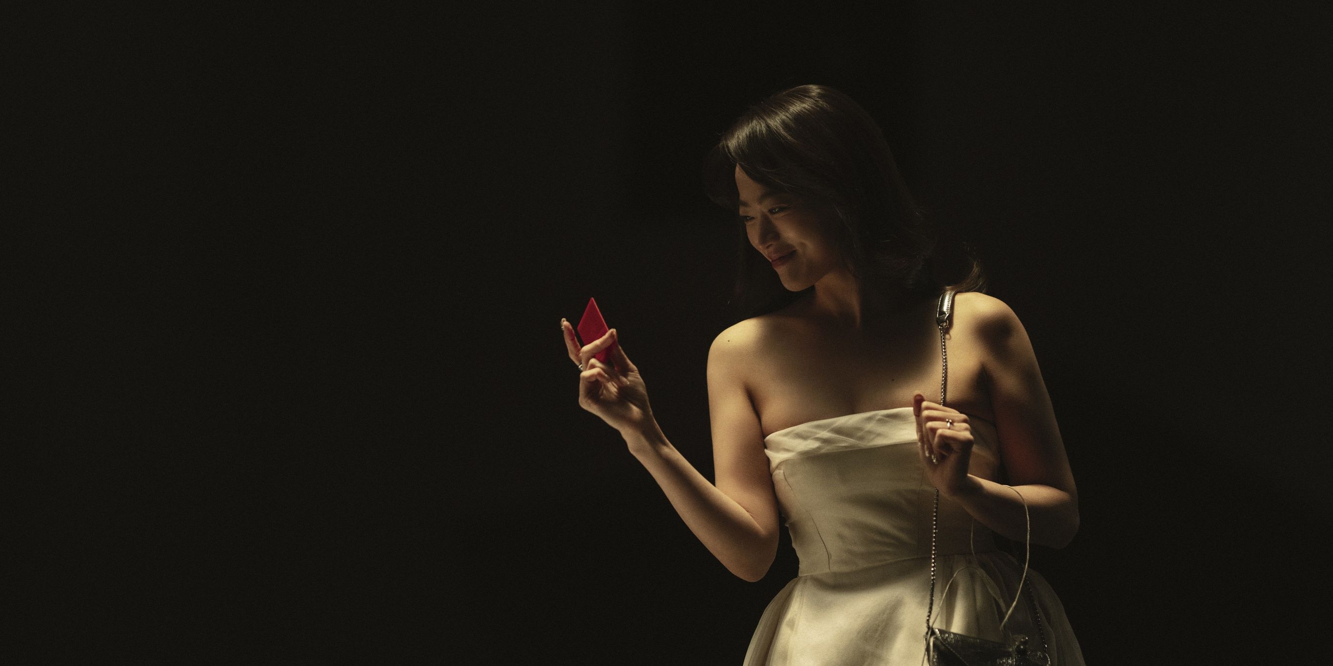 Chun Woo-hee looks at her red key card as Eigth Floor in The 8 Show