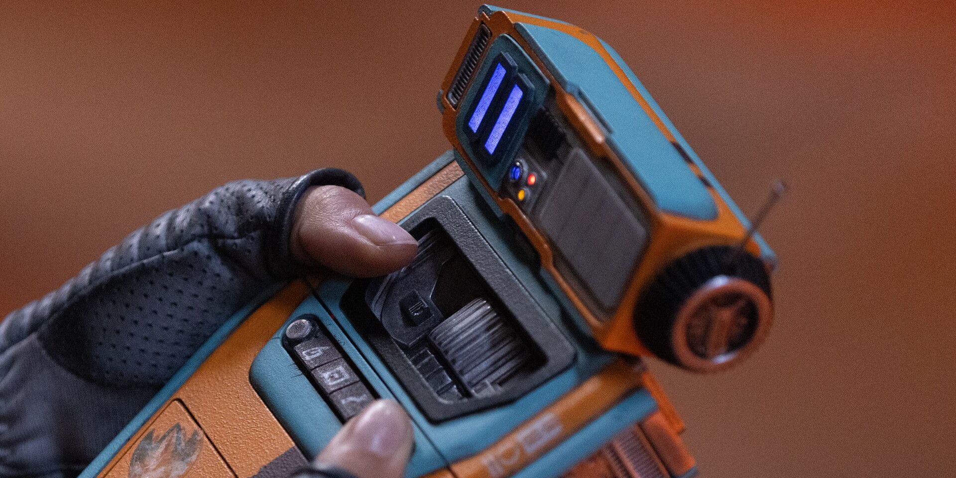 The handheld droid Pip helps a character in 'The Acolyte'